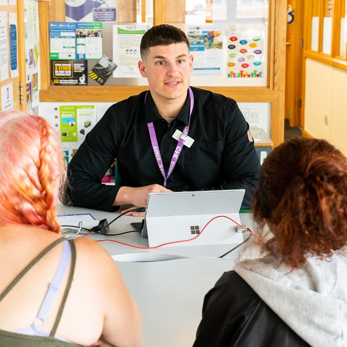 Careers adviser talking to young person and parent